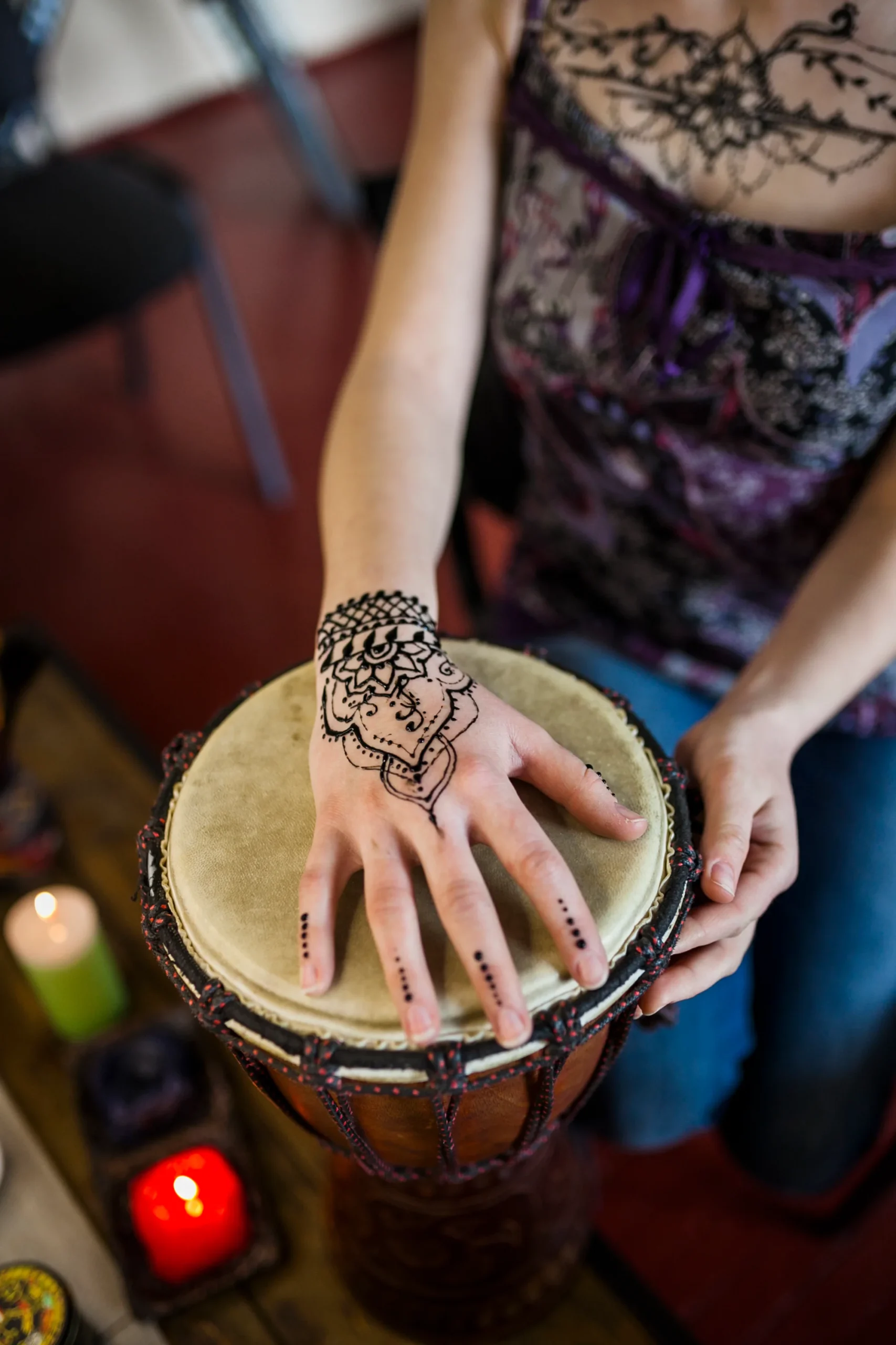 close-up-woman-playing-bongo-drum-with-mehndi-tattoo-her-hand