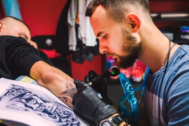 adult-man-working-with-tattoo-pen-arm